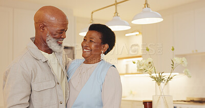 Buy stock photo Laughing, senior couple and hug in kitchen, love and connection with partner on weekend in apartment. Happy people, together and embrace with spouse in home, affection and relationship commitment