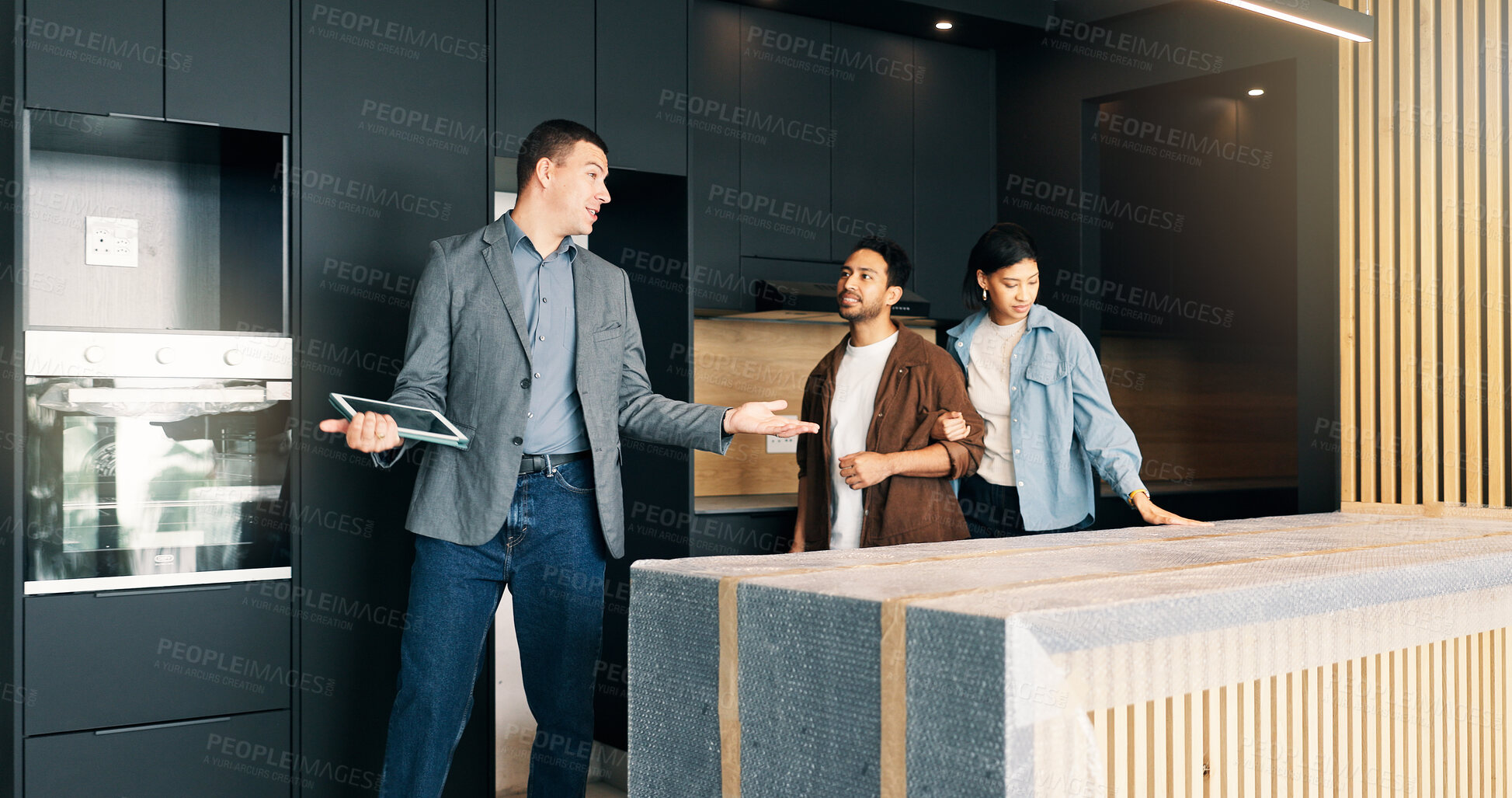 Buy stock photo Couple, relocation and showing with realtor in new home for opportunity, sale or viewing. Bond, kitchen inspection and mortgage loan with people in real estate development for purchase options