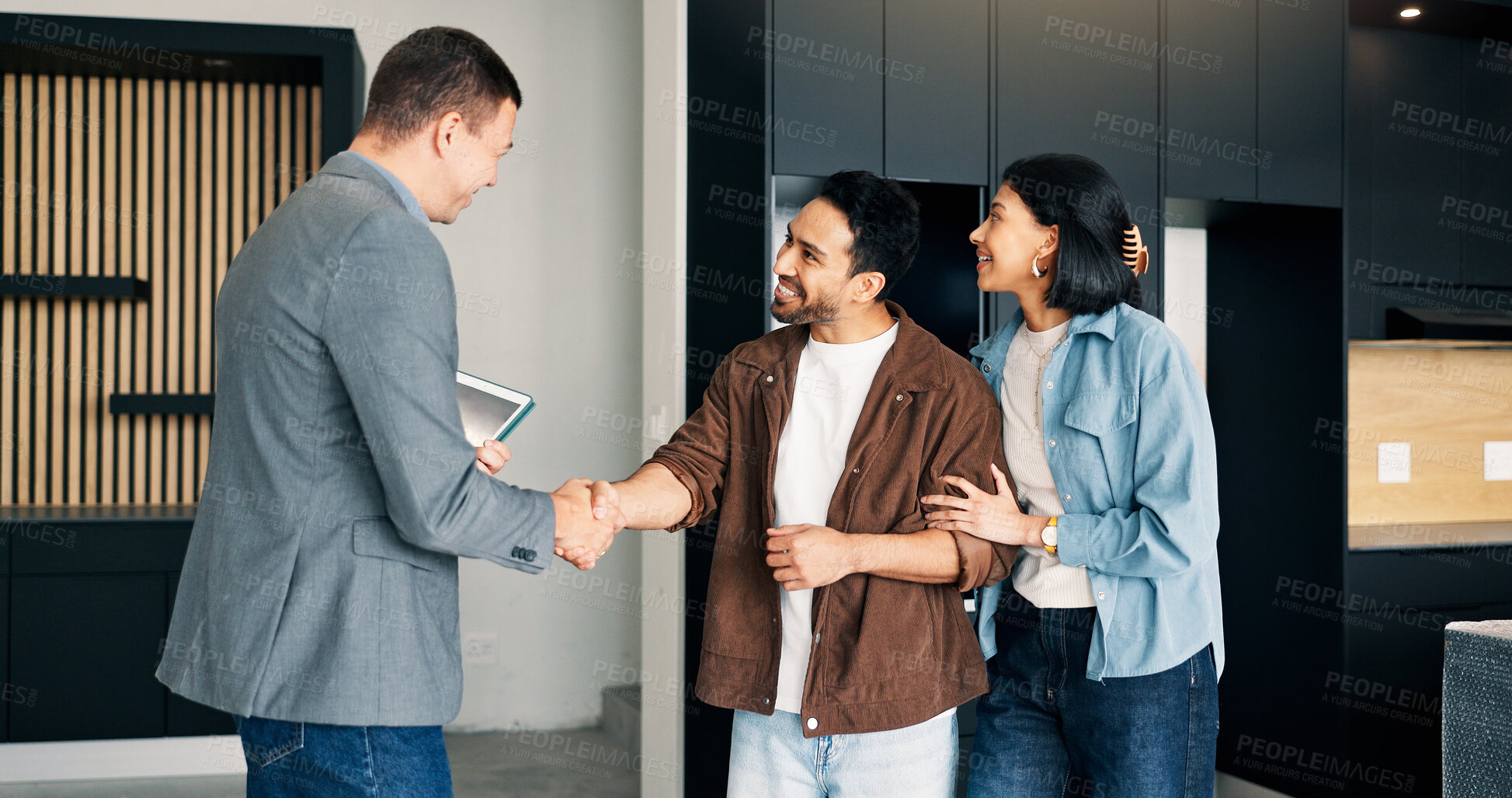 Buy stock photo Couple, handshake and relocation with realtor in new home for deal, sale agreement or investment. Bond approval, mortgage loan and thank you with happy people shaking hands in real estate development