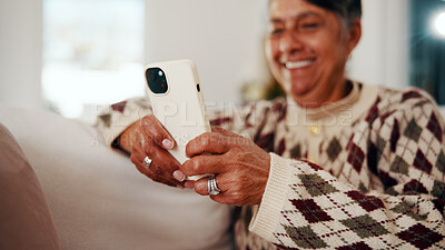 Buy stock photo Text, phone and elderly woman in house with laugh, online communication and comic post on social media. Happy, digital and senior person on sofa with tech, funny message or meme reaction on chat app.