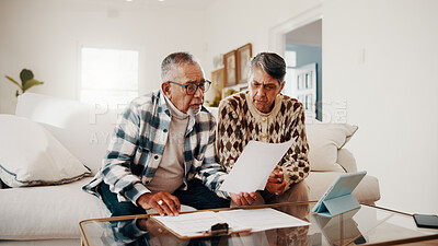 Buy stock photo Documents, confused and senior couple on sofa in home with retirement funds, savings or budget. Review, paperwork and elderly man with woman for planning pension, expenses or asset management.
