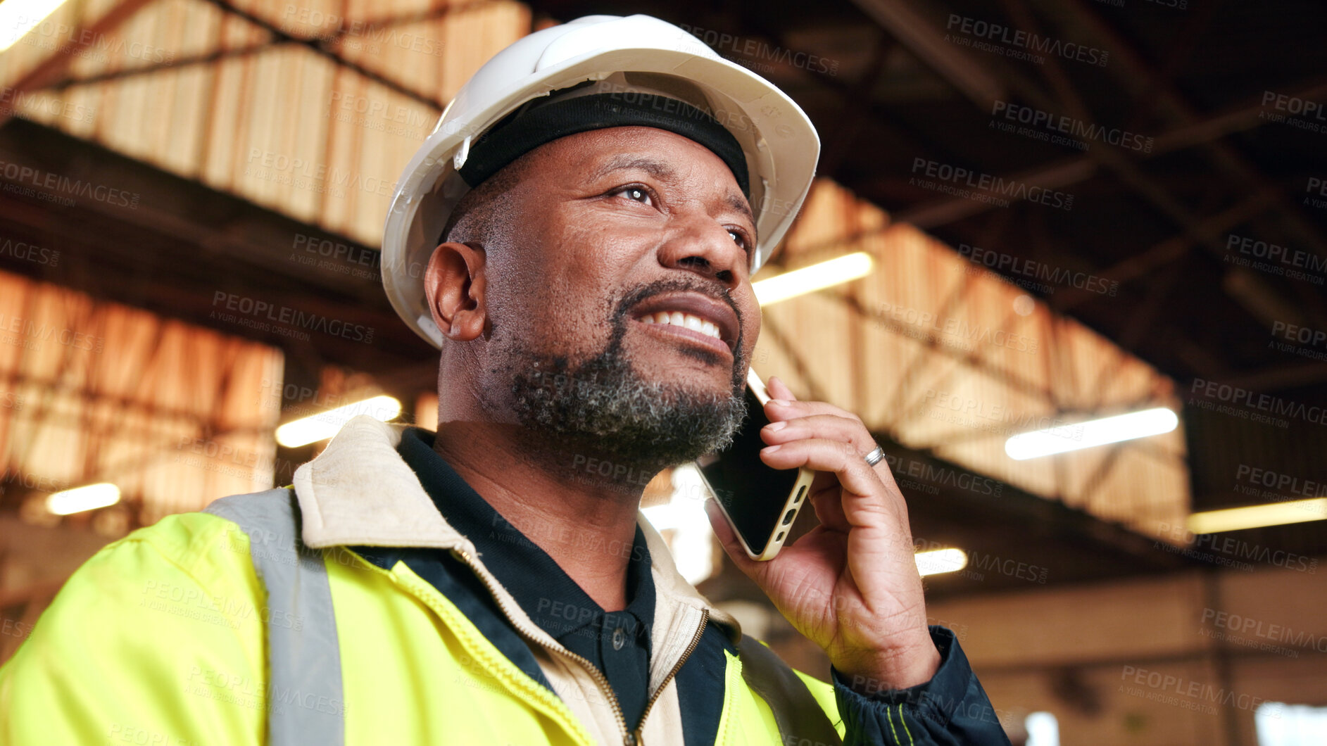 Buy stock photo Construction, phone call and happy black man in workshop for material delivery, feedback or planning. Mobile, engineer and mature person with update, building development or architecture industry