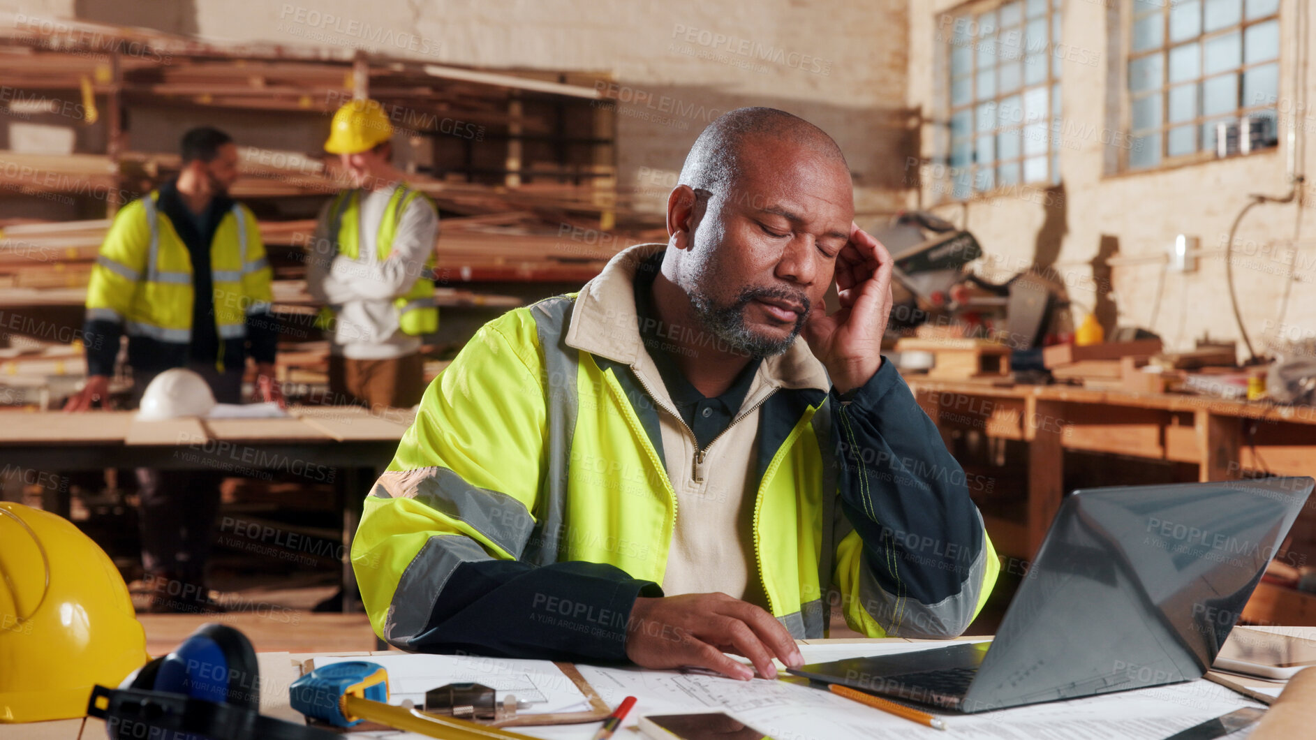 Buy stock photo Carpentry, man and headache in workshop with laptop, exhausted or mistake in supply order. Project planning, tech or mature carpenter in woodworking factory with migraine, stress or deadline pressure