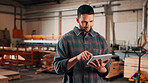 Man, tablet and scroll in woodworking workshop, check lumber order or online inventory management. Carpenter, smile and reading on tech for digital stock analysis or search carpentry merchandise app