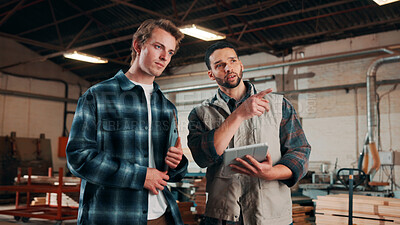 Buy stock photo Men, tablet and meeting in lumber workshop, carpenter and apprentice with discussion for advice in woodwork. Point, talk and supervisor with trainee, tech and team guidelines for carpentry planning