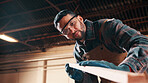 Carpentry, sanding or man in factory with wood, fabrication or quality control in furniture production. Below, ppe or carpenter with plank, timber polishing or manufacturing process in woodworking.