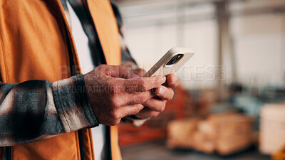 Buy stock photo Carpentry, hands and phone with man in warehouse for feedback, management or planning. App, communication and space with person in woodworking factory for furniture manufacturing or production