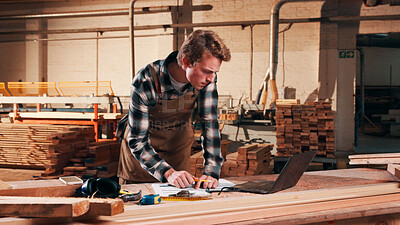 Buy stock photo Carpentry, serious and man on laptop in workshop for planning, schedule or manufacturing quote. Warehouse, male person or carpenter with technology for woodwork or furniture production with paperwork