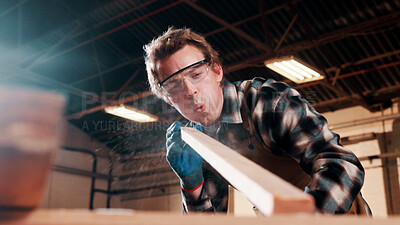 Buy stock photo Carpentry, sanding or man in factory with wood, fabrication or quality control in furniture production. Blowing, ppe or carpenter with plank, timber polishing or manufacturing process in woodworking.