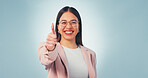 Business, woman and thumbs up portrait in studio with happy review, like or approve on blue background. Professional, feedback or hand gesture with corporate person by space for agreement or yes