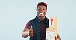 Portrait, boxes and delivery man in studio with thumbs up, postal service and online shopping package. Happy, black person and courier with ecommerce order, like emoji and space on blue background.