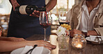 Restaurant, waiter and couple pour wine for date, anniversary celebration and romantic dinner. Hospitality, fine dining and server with people for alcohol tasting for relationship, love and bonding