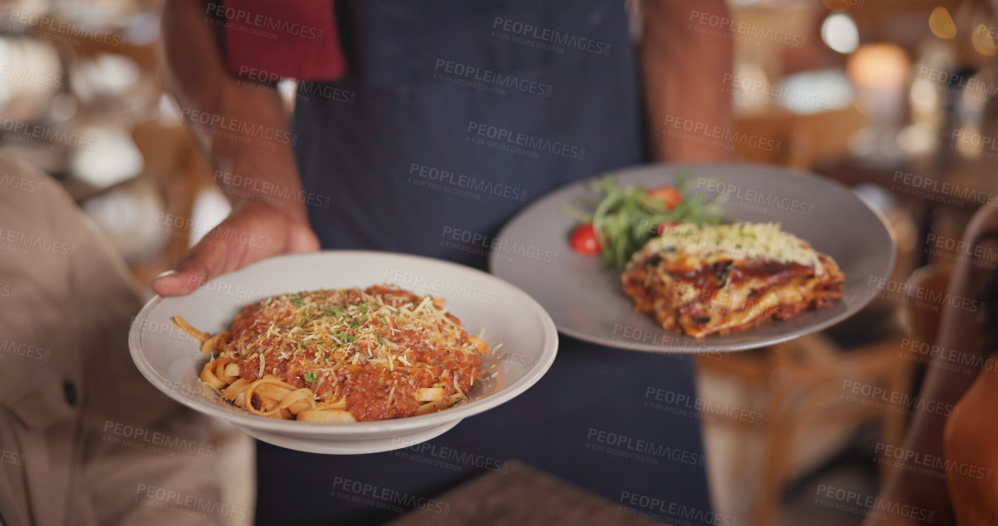 Buy stock photo Hands, waiter and food at restaurant with couple, gourmet meal and fine dining for anniversary. Employee, serving and people with plate for Italian cuisine, spaghetti dish and romance for celebration