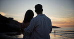 Couple, sunset and hug at beach for travel, sightseeing and romantic date on holiday getaway. Back, people and embrace at seashore with ocean view, commitment and tropical vacation for adventure trip