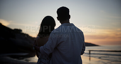 Buy stock photo Couple, sunset and hug at beach for travel, sightseeing and romantic date on holiday getaway. Back, people and embrace at seashore with ocean view, commitment and tropical vacation for adventure trip