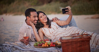 Buy stock photo Love, selfie or couple at beach with picnic, memory capture or social media post on anniversary. Digital, happy or people with fruit basket, partner connection or honeymoon photo on outdoor date.