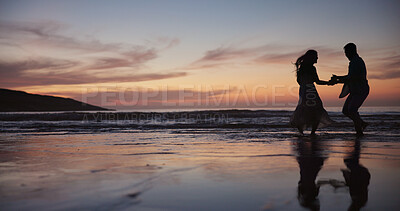Buy stock photo Silhouette, couple and dancing at beach for travel, celebration and romantic date on holiday. Space, sunset and people at seashore with smile, commitment and tropical vacation for adventure getaway