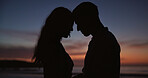 Silhouette, couple and forehead touch at beach, love and partner affection on romantic holiday. Sunset, people and connection at ocean for celebration, commitment and tropical vacation for adventure