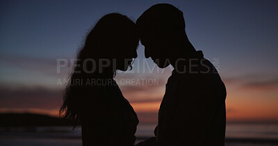 Buy stock photo Silhouette, couple and forehead touch at beach, love and partner affection on romantic holiday. Sunset, people and connection at ocean for celebration, commitment and tropical vacation for adventure