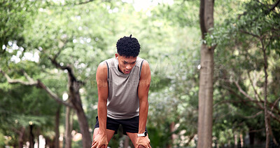 Buy stock photo Tired, man and earphones at park, fitness and sweating after physical activity or exhausted on break. Runner, thinking and listening to music in nature, wellness and person with fatigue on weekend