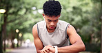 Fitness, man and outdoor with smart watch for time, tracking distance and change music with earphones. Runner, tech and timer in nature to monitor cardio, notification and select audio on break