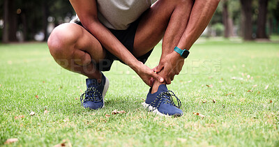 Buy stock photo Park, person and ankle pain with hands, fitness and grass field for exercise and workout with muscle tension. Man, athlete and runner with accident, overworked joint and burnout from training
