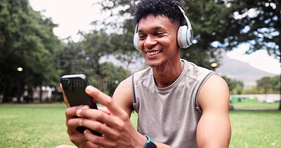 Buy stock photo Fitness, headphones and man with phone, texting or laughing with message on social media app at park. Happy, athlete and person with mobile for workout update, chat and listening to music on break