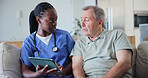 Medical, tablet and nurse talking to old man in home living room for consulting or feedback. App, healthcare and support with caregiver speaking to senior patient in apartment to explain results