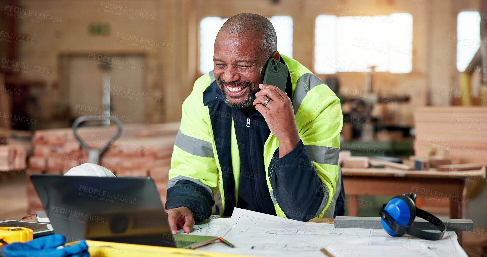 Buy stock photo Architect, laptop and phone call with black man for communication, planning or woodwork. Happy, floor plan and technology for feedback, process and discussion for custom carpentry at warehouse