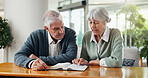 Conversation, bible and senior couple in home with faith, spiritual wellness or religion in marriage. Discussion, reading and elderly man and woman with holy book for praise, gospel or scripture.