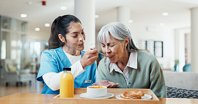 Buy stock photo Assisted living, breakfast and nurse feeding old woman in dining room for help, care or support. Eating, food and retirement with senior person in home for healthy diet, nutrition or wellness