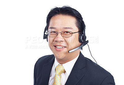 Buy stock photo Asian call operator looks at you as he takes a call on his headset - Isolated on white