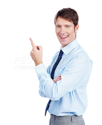 Buy stock photo Happy business executive points upwards at a potential product - Copyspace