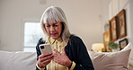 Stress, old woman and chest pain at house with phone, research and symptoms for heart attack. Discomfort, senior person and mobile app for cardiac emergency, urgent assistance and medical condition