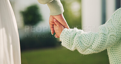 Buy stock photo Parent, holding hands and support for child, outdoor and connection with mom on weekend or childcare. Family, together and person with kid on break, development and bonding with mother at house