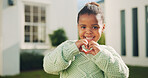 Smile, backyard and portrait of child and heart hands for real estate support, positive attitude and care. New house, security and love symbol with girl outdoor of home for hope, peace and trust