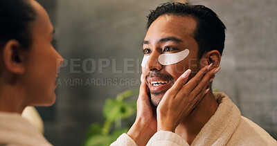 Buy stock photo Couple, skincare and eye patch in bathroom for morning routine, dermatology and reduce dark circles. People, romantic relationship and collagen mask in house for clear skin, cosmetics and grooming.