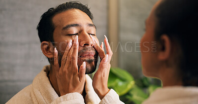 Buy stock photo Couple, skincare and apply moisturizer in bathroom with morning routine, love or hydration benefits. People, romantic relationship and face cream in home for clear skin, cosmetics or bonding together