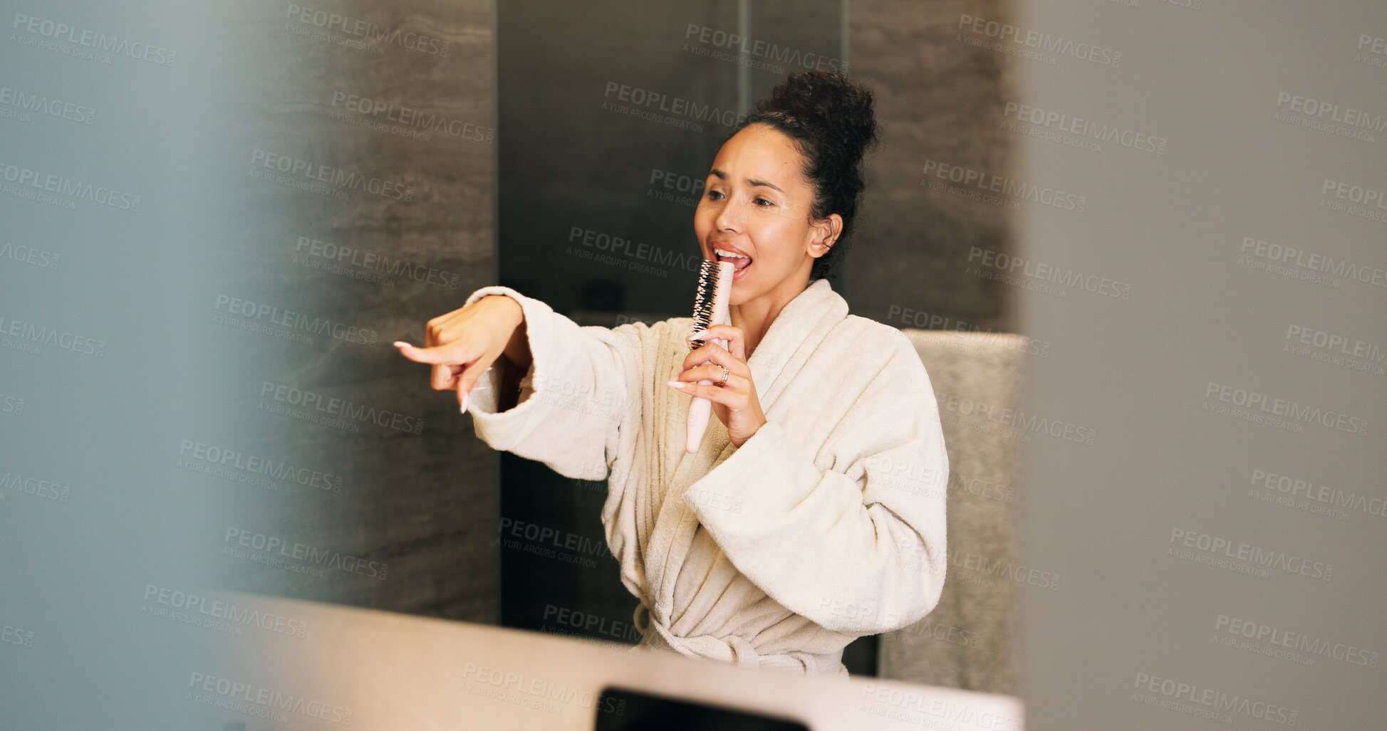 Buy stock photo Woman, singing and hairbrush in home with bathroom mirror, morning routine or good mood for wellness. Space, person point and karaoke in house with cosmetic tool, reflection or grooming for self care