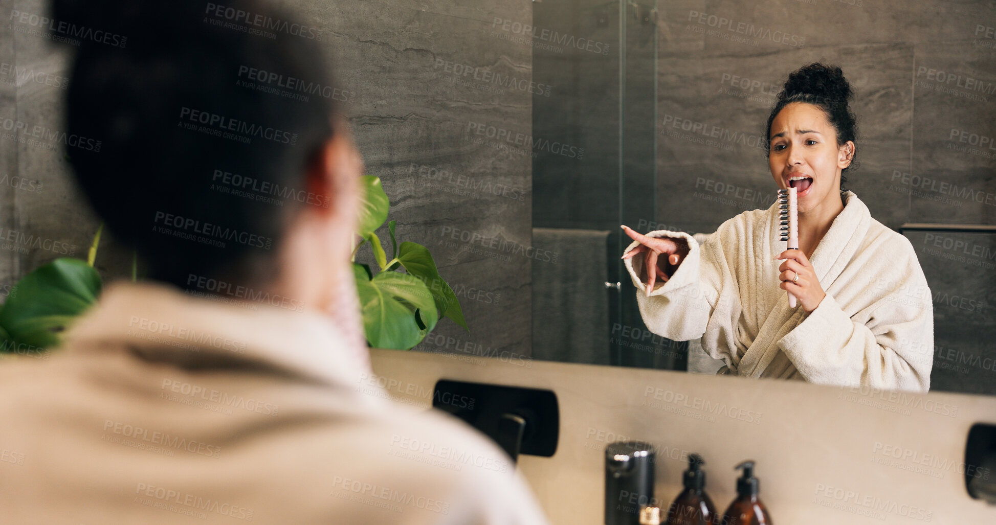 Buy stock photo Woman, singing and hairbrush in house with bathroom mirror, morning routine or good mood for wellness. Female person, point or karaoke in home with cosmetic tool, reflection or grooming for self care