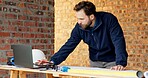 Laptop, architecture and man with drawing, construction site and urban development or remodeling. Tech, person and employee for engineering, property and infrastructure for safety and quality control