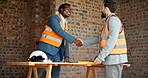 Architect, men and handshake on construction site, agreement and teamwork for real estate investment. Happy people, shaking hands and collaboration for property development and success in building
