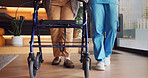 Legs, rehabilitation and walker with people in clinic together for balance or stability. Healthcare, physiotherapy and walking frame on wheels for exercise or recovery of patient in wellness session