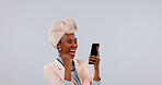 Studio, celebration and woman with phone, laughing and good news on social media app or notification. White background, success and black person with mobile, mockup space and happy for announcement