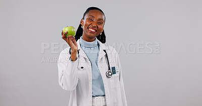 Buy stock photo Portrait, doctor and black woman with apple in studio for healthy diet on a white background. Female person, healthcare worker or smile with natural organic fruit for nutrition or wellness on space