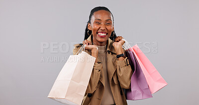 Buy stock photo Happy, portrait or black woman with shopping bags in studio for discount on a white background. Female person, shopper or smile with gift, order or presents for payment spree, store promotion or deal