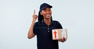 Buy stock photo Pointing, portrait and black woman in studio for delivery, shipping and info for courier service. Mockup, space and happy person with box for ecommerce, logistics and advertising on white background