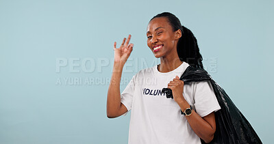 Buy stock photo Volunteer, portrait and black woman with okay sign, happy and trash or cleaning garbage in studio. Non profit, community service and space for wink, success and plastic bag on blue background