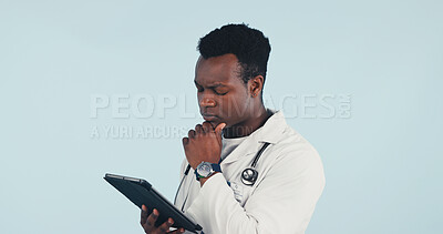 Buy stock photo Thinking, doctor or black man with tablet in studio for medical procedure on a blue background. Thoughtful, male person or healthcare worker contemplating with technology or app for research or study