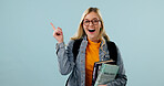 College student, education and woman point in studio, science knowledge and space for ads. Learning, books and excited person with mockup promo, biology scholarship or portrait on blue background